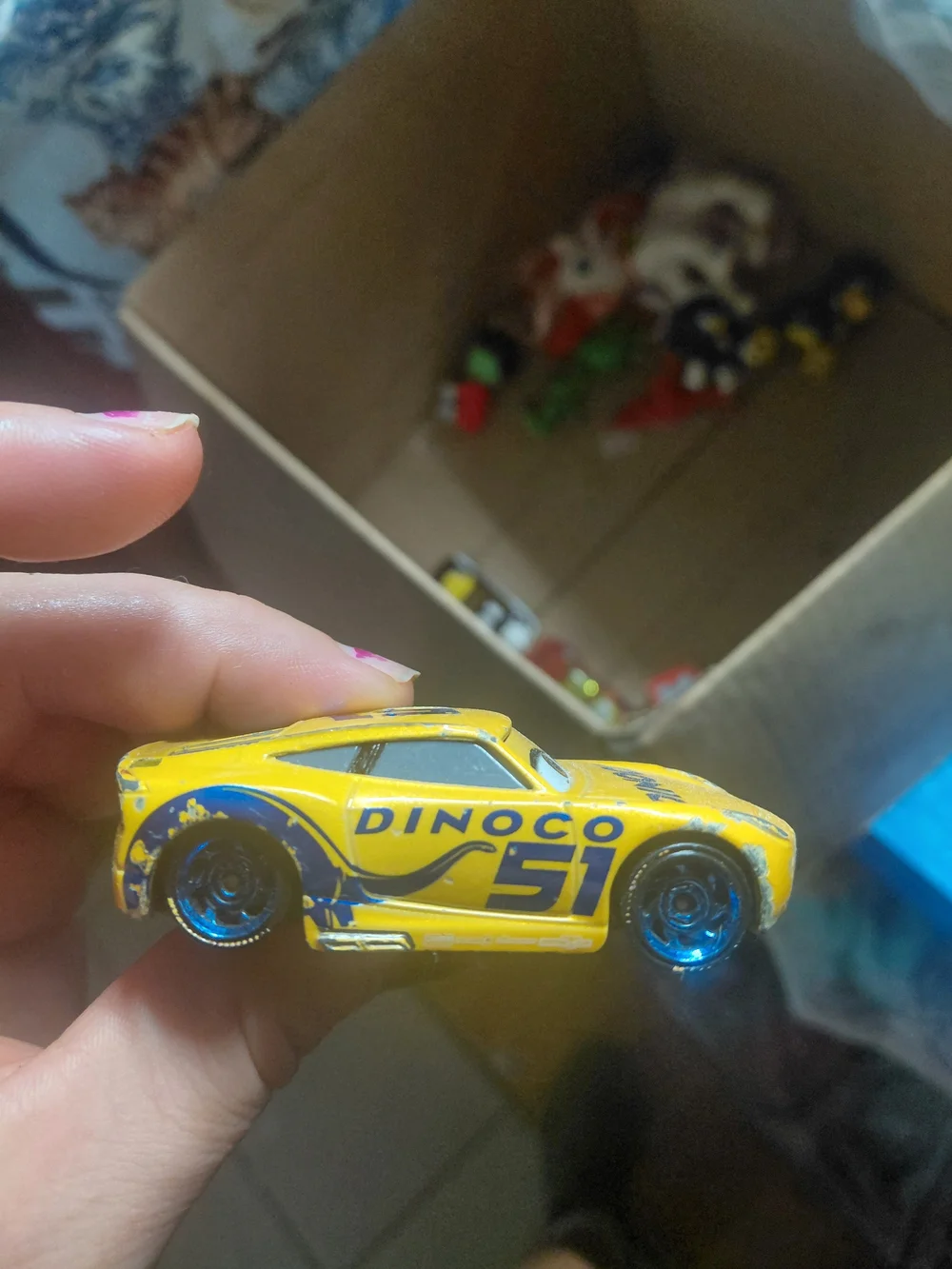 Disney Pixar Cars Cruz Ramirez die-cast toy car in her yellow Dinoco racing live